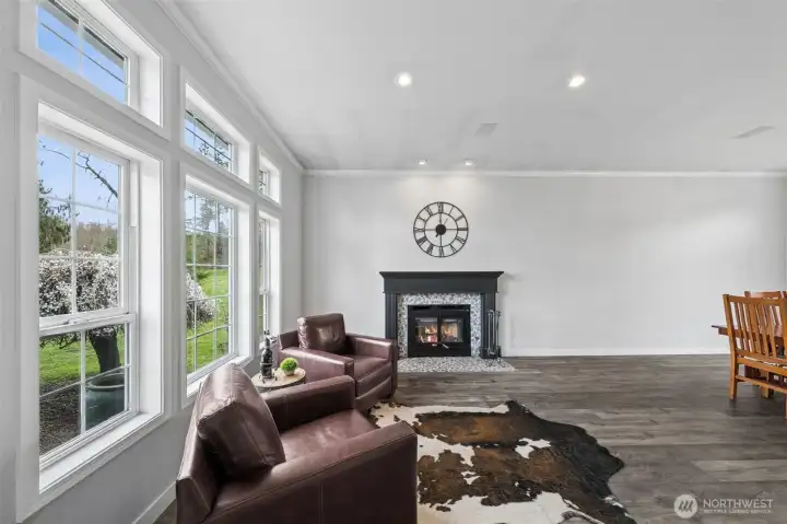 Just off the entry is the formal living area with propane/gas fireplace and three large windows.