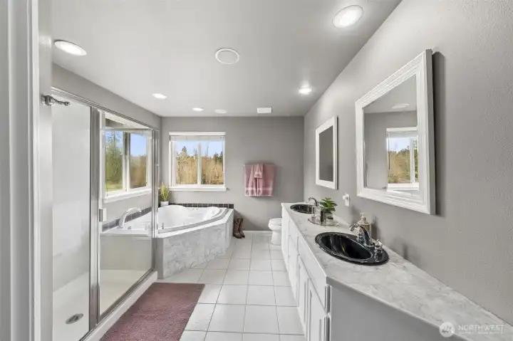Spa like en-suite with double sink vanity, oversized jetted tub, surround sound + walk- in shower!
