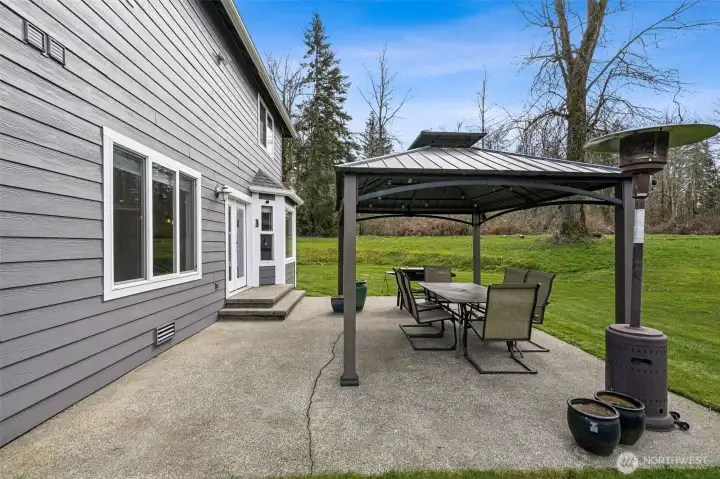 Oversized patio located just off the kitchen area- the gazebo cover will keep you cool on summer days while you watch the horses graze peacefully.
