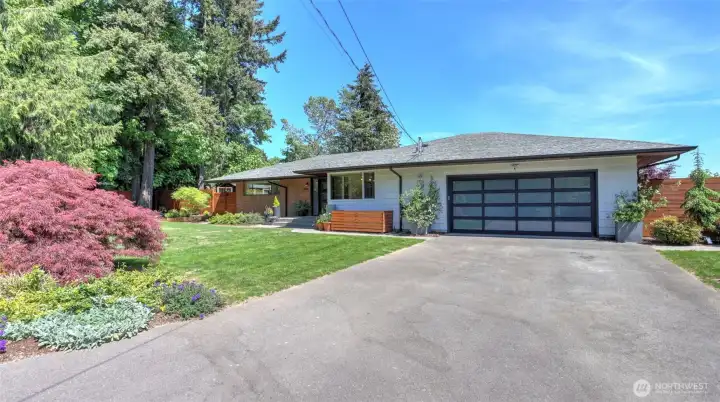 With its expansive views of The Cascades and Mount Rainier, this thoughtfully remodeled home blends original character with high-end updates throughout.