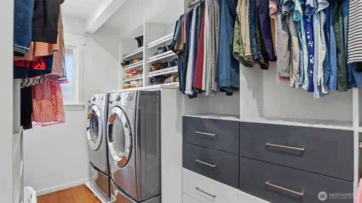 Walk in closet with laundry in primary!