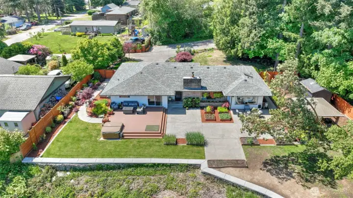 Step outside and the lifestyle comes to life. This home's park-like setting features large composite decks, a large patio, hot tub, outdoor kitchen, gazebo, over a dozen garden beds, and extraorniary wildlife.