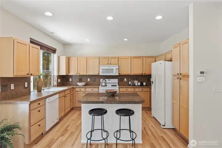 The center island anchors the kitchen offering ample workspace, and comfortable seating for everyday meals and conversation.  All the appliances remain with the sale of the home.
