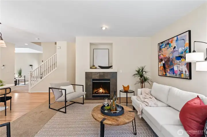 A comfortable family room with a gas fireplace opens directly to the kitchen and casual eating area, offering an ideal open-concept layout for both relaxed living and entertaining guests.