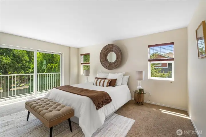 Spacious Primary Suite is filled with natural light and features a private deck, creating a peaceful retreat for morning coffee, relaxation,or unwinding at the end of the day.