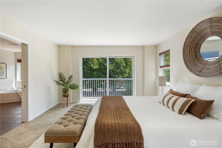 The primary bedroom offers a peaceful retreat with direct access to a private deck perfect for relaxing outdoors and enjoying views of the backyard.