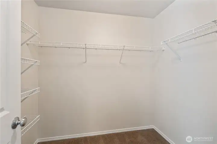 The primary suite offers a walk-in closet for added storage.