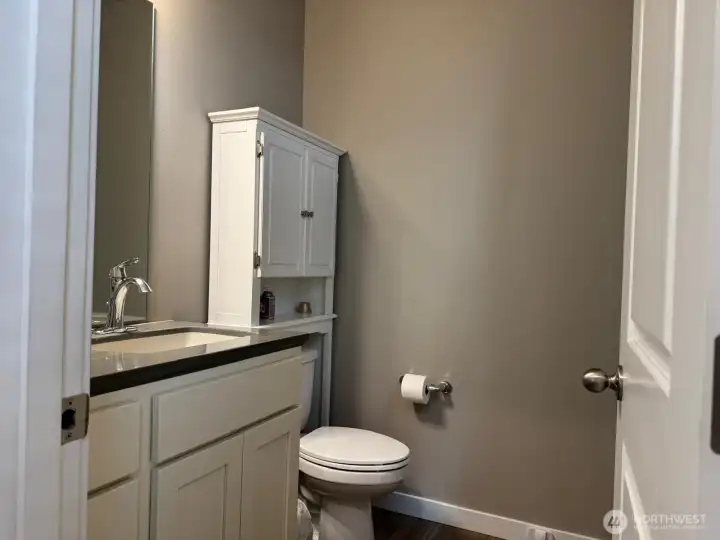 This half bath is down a little hall behind the refrigerator wall. This half bath is down a little hall behind the refrigerator wall.