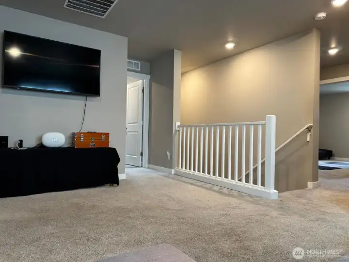 Just at the top of the stairs is the loft. You can see bedroom 2 in the background Just at the top of the stairs is the loft. You can see bedroom 2 in the background