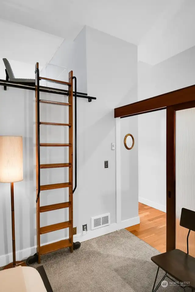 Sliding doors close off the bedroom. The ladder is access to the loft area.