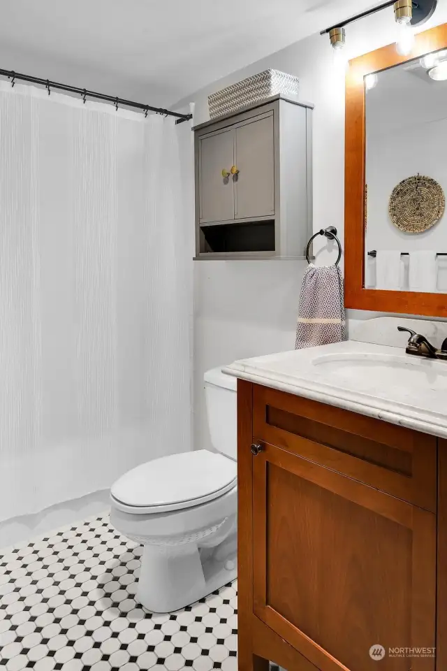 Full bathroom with ceramic tile floors & tub/shower surround.