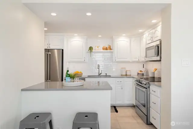 Remodeled kitchen and bathrooms, including opening wall with added breakfast nook and new buffet with added window and wine fridge.