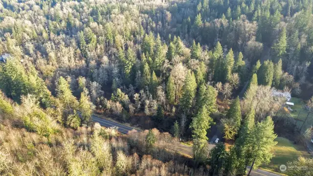 Drone Shot with Ames Lake-Carnation Rd NE with car heading down NE 52nd St with property to the right of Ames Lake-Carnation Rd and the left of NE 52nd St