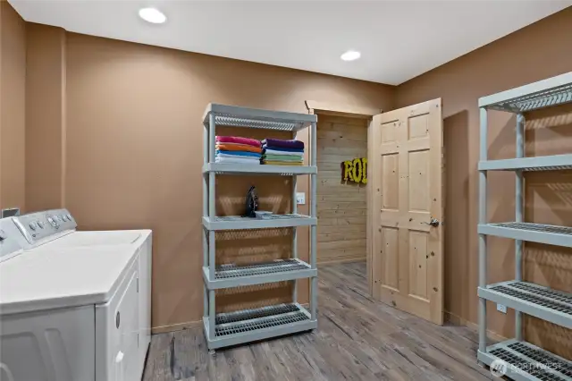 Basement Utility Space: The basement of this house features a utility space with a washer, dryer, and tons of storage.