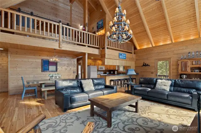 I love the mountain flair chandelier in the dining room, plus they've got tongue and groove ceilings, and you can see the loft and the upstairs bedrooms from here.