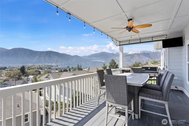 Main level deck. Gas Bistro table and BBQ.  Outdoor fan for a nice breeze in the hot weather. TV included.