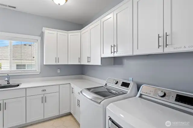 Large main floor utility room with lots of storage.