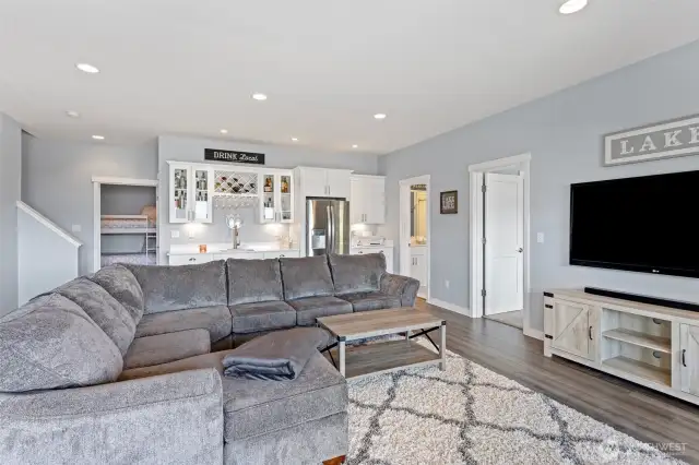 Lower-level family room with wet bar and refrigerator.