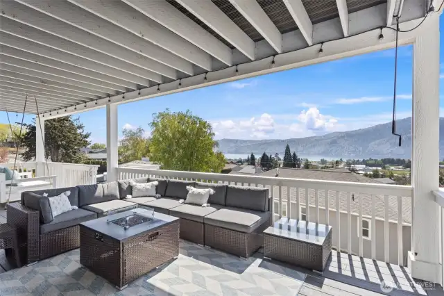 Lower-level composite deck.  Gas fire table and sectional.