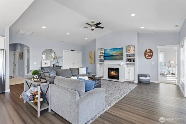 Great room with vaulted ceiling and fan.  Gas fireplace.  Double front doors.