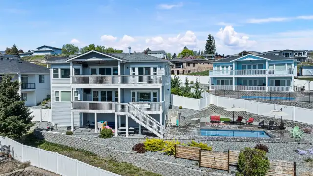 View of the backside of the house.  Note the area below the lower level.  There is an area of unfinished basement and a door for a lot more additional storage space.