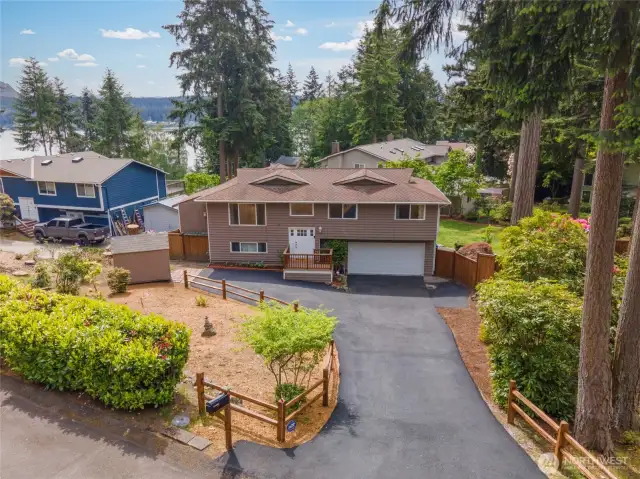 This home underwent major updates in 2017, including a new roof, vinyl windows, and many interior updates. The current owners have further enhanced the property by removing trees, installing new fencing, upgrading the electrical panel, recent new carpet and pad, and adding a two-step water filtration system. The revitalized landscaping is also designed for easy maintenance.