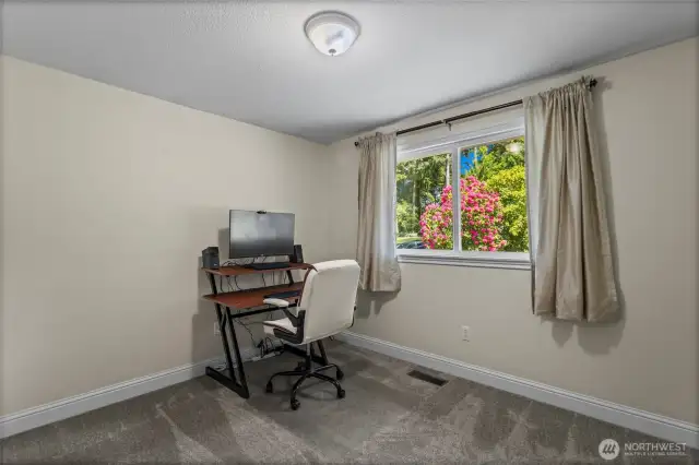 Ideal for use as either a bedroom or an office, this upstairs space boasts new carpeting, updated trim, and a bright, sunny window.