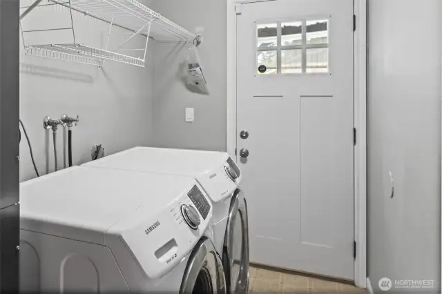 The downstairs laundry room features a door leading to the backyard and a convenient path to the adjacent bathroom when working in the yard or coming in from the hot tub.
