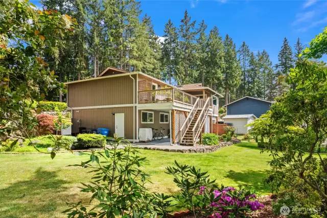 Established and colorful landscaping, vibrant green grass, and abundant sunshine make this backyard truly exceptional.