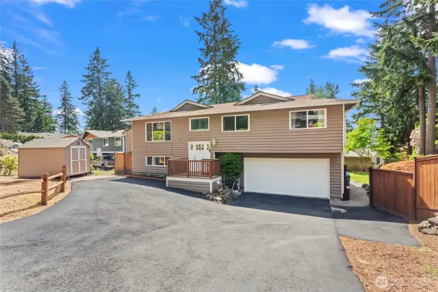 With ample room for parking, the fresh approach to the home is so inviting. Notice the shed to the left for added storage needs. Let's go inside!