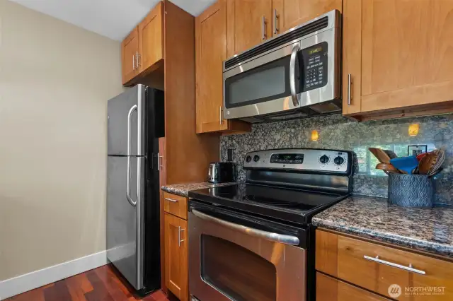 The Kitchen is where the magic happens!  Gorgeous stainless steel appliances and plenty of shaker cabinetry for storing the kitchen tools and gorgeous slab granite.