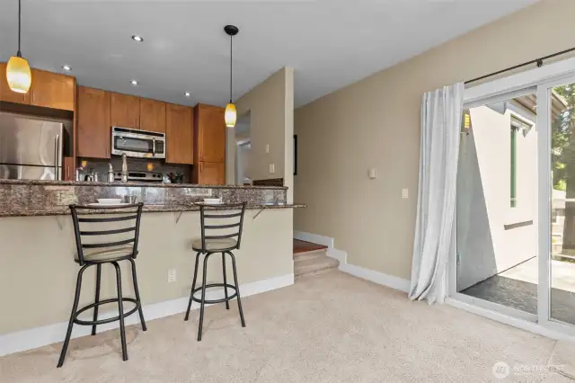 In addition to the windows, there is a sliding glass door to an east-facing balcony.  Just 2 stairs into this portion of the main living area.