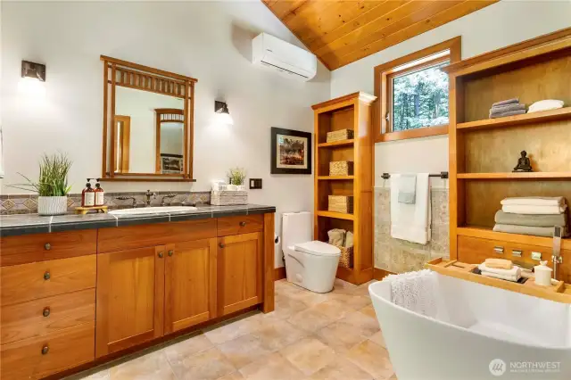 Deep soaking tub is a great addition to this spa-like bathroom.