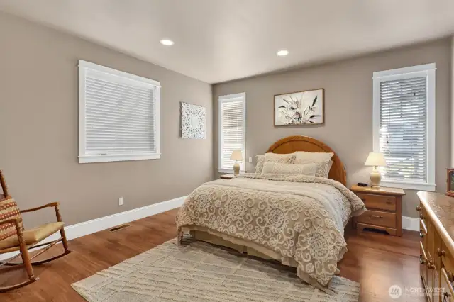 Main Floor primary bedroom with attached bath en-suite and walk-in-closet.
