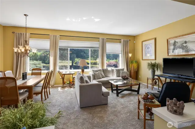 Living room with dining room opens up to the back yard views.