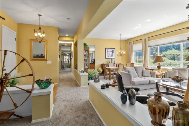 Looking down hallway front entry and living room, lots of light in this beautiful open floor plan one level living home.