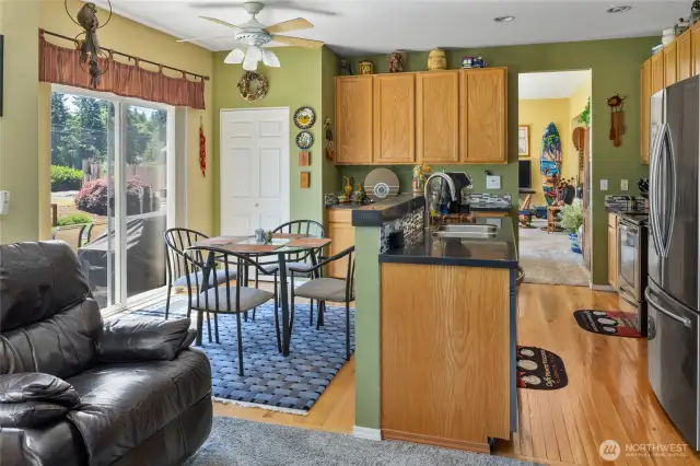 Kitchen was updated with granite counter tops, tile backsplash and oak cabinets, also features a ceiling fan and REAL hardwood floors!