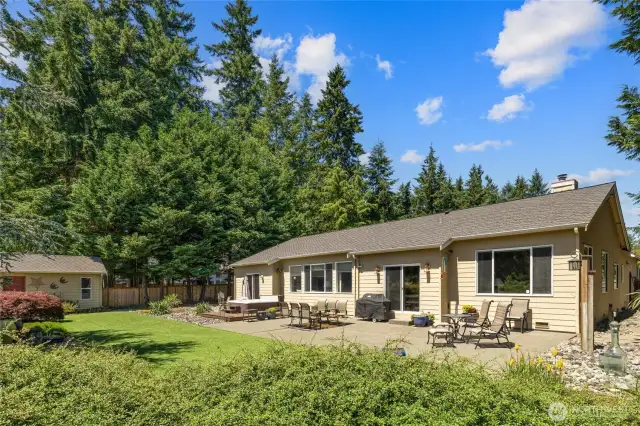 Turf yard, extra large concrete patio and beautiful mature landscaping.