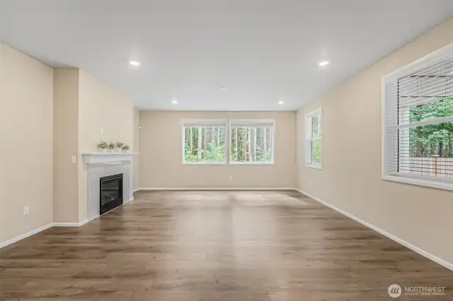 Living room features scenic wooded views of the protected area behind.