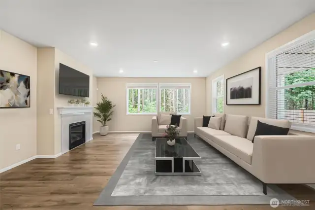 Many windows and tall ceiling bathe the living room in natural light.