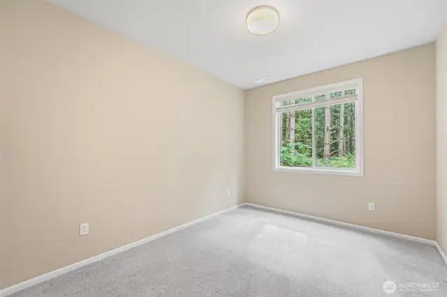 Main floor bedroom with wooded view.