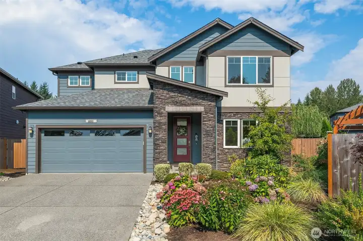 Front view of home with lovely landscaping.