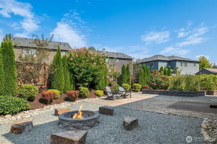 For those who prefer not to spend a weekend mowing, this professionally landscaped back yard offers a beautiful firepit with seating, a large patio waiting for your el fresco dining, raised flower bed and raspberry bushes bed, a pet care area, a garden shed, and easy care maintenance.