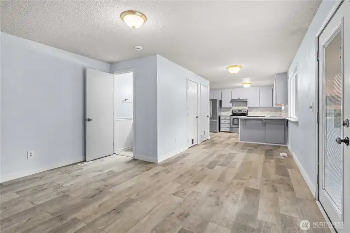Dinning room or bonus space looking at half bath into the kitchen