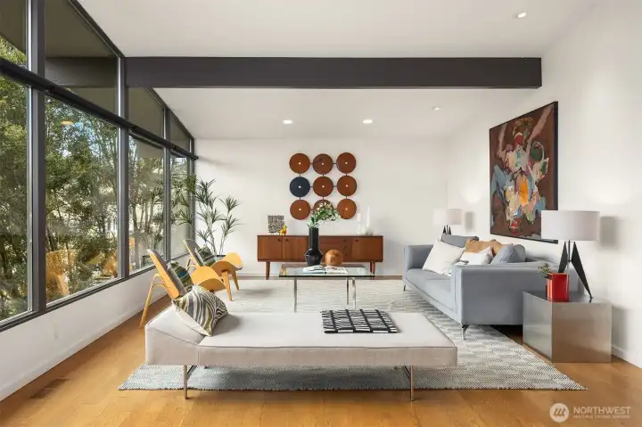 Expansive windows span the entire west-facing back of the home, with vaulted ceilings, clerestories, and exposed beams popping against perfectly-smooth white walls; future backdrop for your statement art.