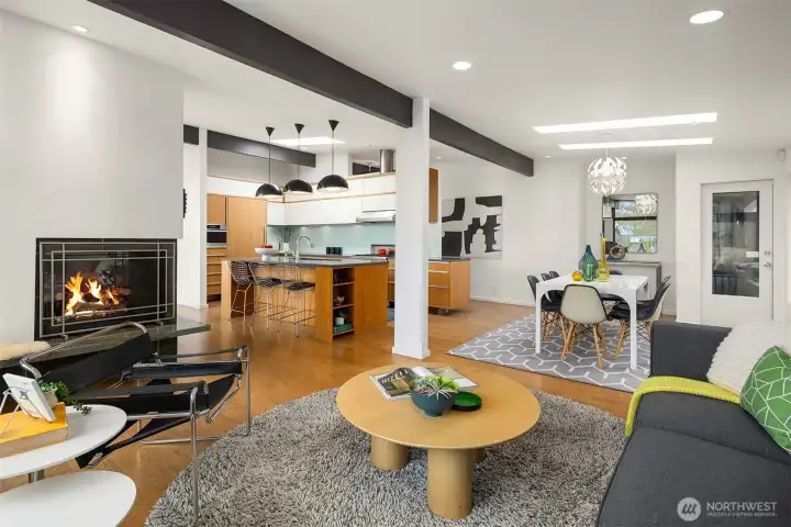 The hallway to the left of the dining table circles behind the kitchen back to the entry and leads to the 3 bedrooms/2 bathrooms on this floor...