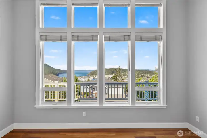 And there is the view under dramatic, high ceilings and windows. Wood blinds to manage the light and view.