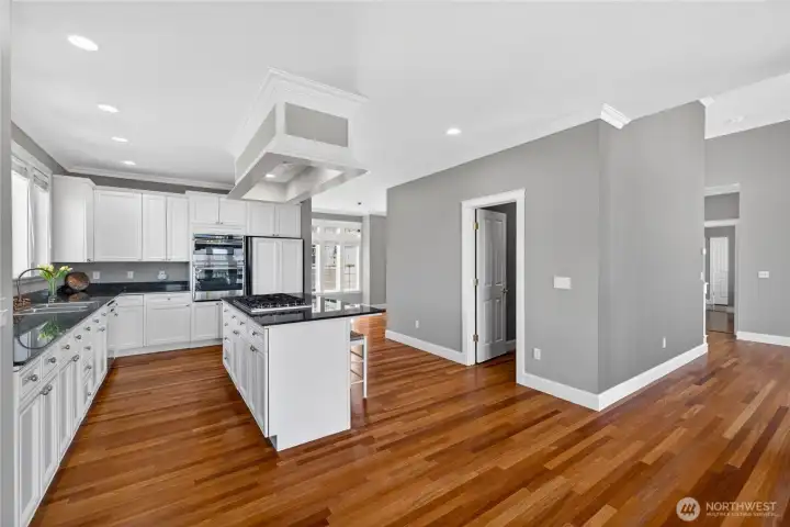 Traffic flows from the entry, through the kitchen nook to the kitchen, to the dining room and past the fireplace to the living room.