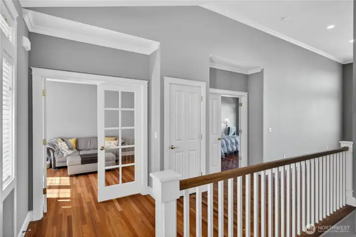 From the main entry, move into the den or office room. See the primary bedroom door just beyond.