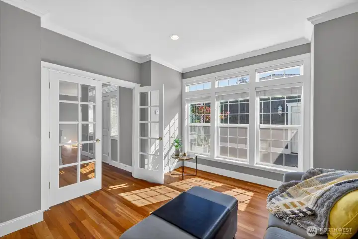 The den or sitting room is light and bright, looking out into the courtyard. It has beautiful French Doors too.
